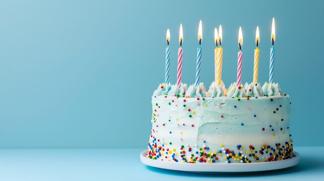 Birthday cake with 6 candles pastel blue birthday background with copy space.