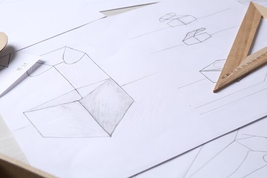 Creating packaging design. Drawings and ruler on table, closeup
