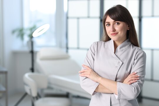 Cosmetologist in medical uniform in clinic, space for text