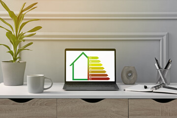 Energy efficiency rating on laptop display. Workplace with modern computer