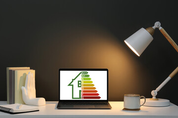 Energy efficiency rating on laptop display. Workplace with modern computer