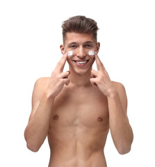 Fototapeta premium Handsome man applying moisturizing cream onto his face on white background