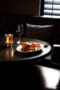 BBQ cheeseburger and fries in a dark restaurant