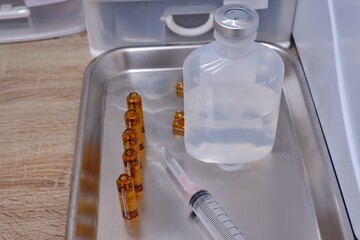 Medicine ampules and infusion bag are on the stainless steel, needle syringe, Hospital, Sodium...