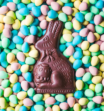 Close up of chocolate bunny on mini chocolate Easter eggs.