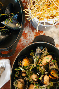 Overhead view looking down at mussels and crispy potatoes