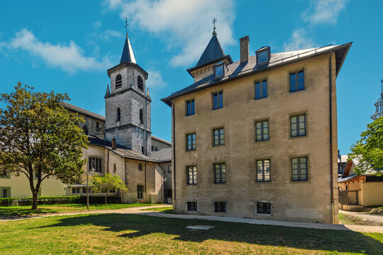 Belfry of the cathedral and the parish under blue sky in Chambery, France.