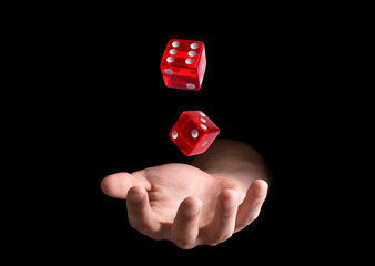Man throwing red dice on black background, closeup