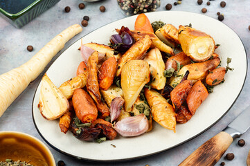 Baked parsnip root and carrots.