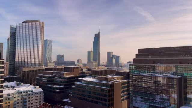 Winter Sunlight Over Warsaw's Modern Skyline. Snow-Capped Buildings