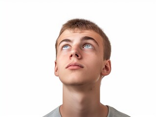 Obraz premium Young man looking up on white background, closeup portrait of face with eyes and eyebrows, handsome young guy, brown hair, studio shot, high resolution photography