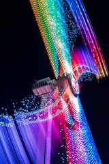 Carnival lights at night - The fun of summertime carnival and fair rides at night with colorful...