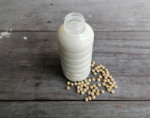 Soy milk with soybean on wood background