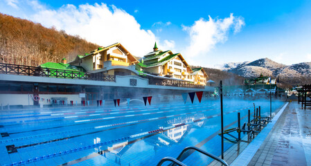 KRASNAYA POLYANA, SOCHI, RUSSIA – winter JANUARY: «Laura, GAZPROM, GRAND HOTEL POLYANA» – the warm swimming pool with view on mountains.
