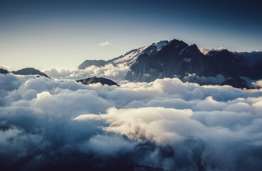 Morning fog shrouded the rocky peaks. Glacier Marmolada, Italian Alps, Dolomites, South Tyrol,...