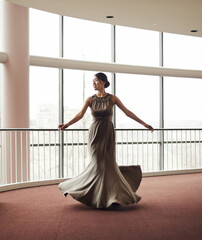 Woman, elegant dress and dancing in hallway, fashion and classy garment in lobby for event. Female...