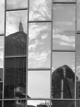 
Black and white image reflecting the shadow of the sun on the glass of the building
