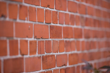 Brick wall, closeup or focus with blur or strong for house, construction with concrete and mortar. Texture, background or zoom with center and haze for building, pattern or architecture or stone