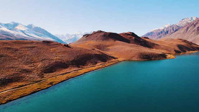 Aerial view of natural glacier lake surrounded by Himalaya mountains. Chandra Taal lake in Spiti Valley, India. Beautiful aerial view of famous Chandratal lake. Nature landscape drone shot.