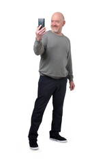 front view of a man  turned taking a self-portrait with smartphone on white background