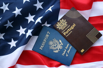 Passport of Portugal with US Passport on United States of America folded flag close up