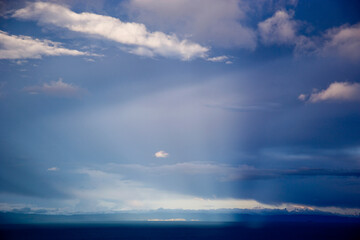 Majestic sky with stunning light beams showcasing weather dynamics over a tranquil landscape
