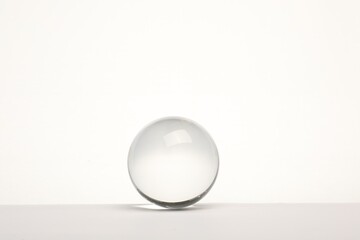 Transparent glass ball on white background. Space for text