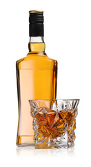 Glass and bottle of whiskey isolated on white