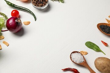 Cooking dinner. Different vegetables and spices on white wooden table, space for text