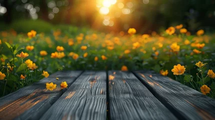 Deurstickers A wooden table with a view of a field of yellow flowers © itchaznong