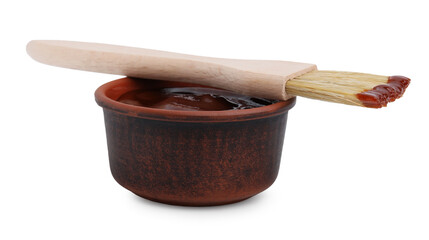 Marinade in bowl and basting brush isolated on white