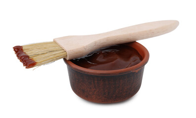 Marinade in bowl and basting brush isolated on white