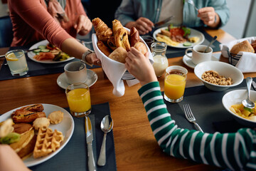 Close up of family having breakfast at dining table in  hotel.