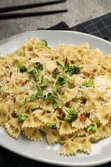 Vegetarian meal. Tasty pasta with fresh vegetables and cheese on table, closeup