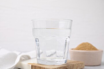 Dietary fiber. Glass of water and psyllium husk powder on table