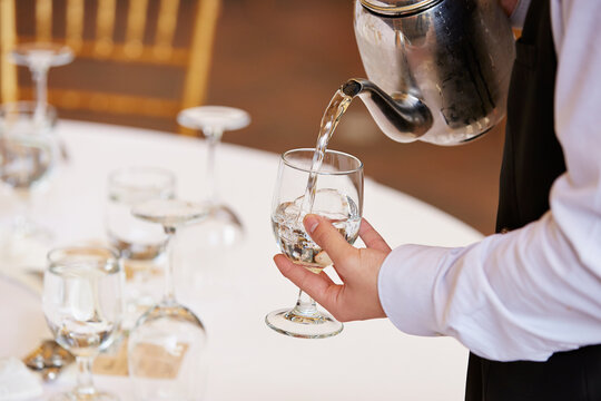 Waiter serving water in a restaurant