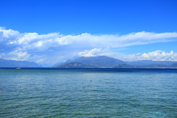 Lago di Garda, view to the lake and Alps covered with snow in background, Italy