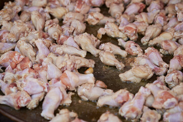 raw chicken legs in a pan