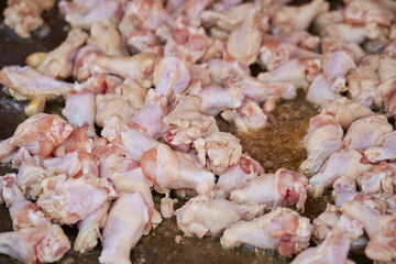 raw chicken legs in a pan