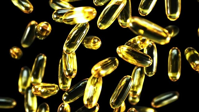 Super slow motion omega 3 vitamin capsules soar up and fall down. High quality FullHD footage