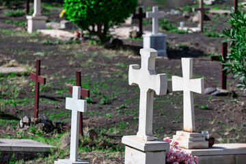 Stone crosses dotting the landscape of the cemetery create a reverent atmosphere