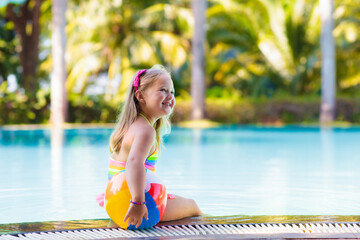 Child in swimming pool with ball. Kids swim. - 780396200