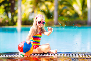 Child in swimming pool with ball. Kids swim. - 780399057