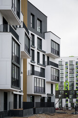 Luxurious apartments for sale. High block of flats living area. New build neighborhood modern style. Real estate market in Europe