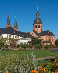 Vertical shot of the Kloster Seligenstadt monastery in Germany surrounded by a beautiful garden