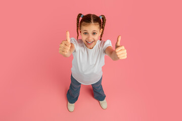 Girl giving thumbs up with confident smile