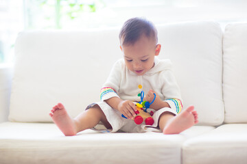 Baby boy playing with toy train - 780404836