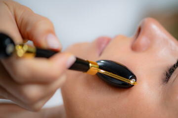 Therapeutic benefits of Guasha facial massage using a jade stone roller, renowned for promoting...