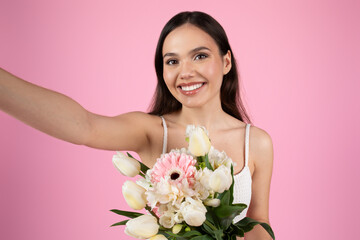 Lady taking a selfie with pink flowers