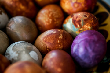 Colorful Easter eggs in brown plate